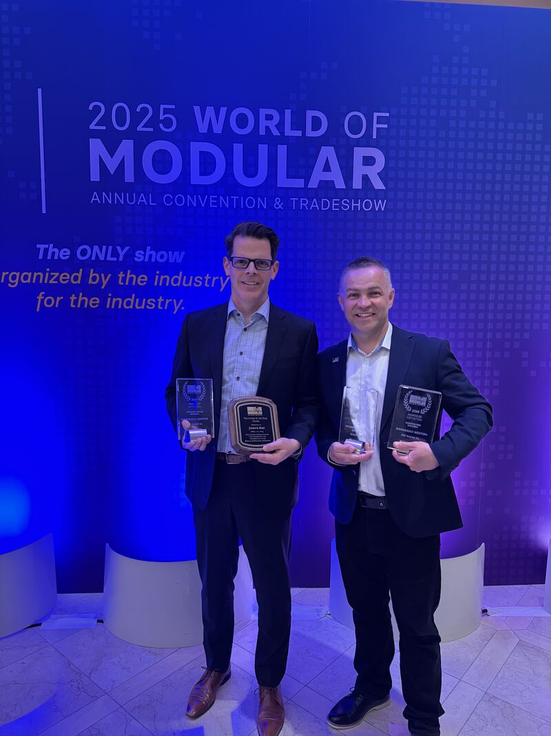 Rhys and Joe standing at World of Modular with their awards.