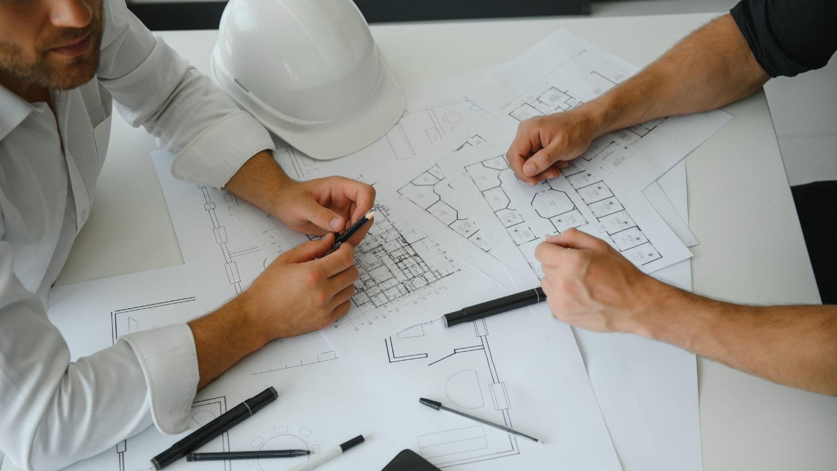 Overhead view of architect and modular construction PM working together