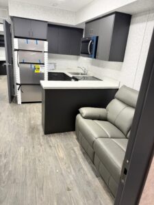 Interior shot of remote sleeper with couch, kitchen and new fridge.